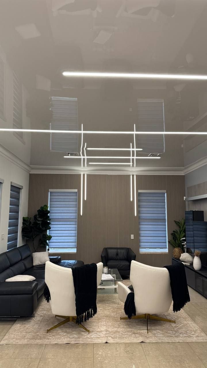 Double-height living room with crossing light lines